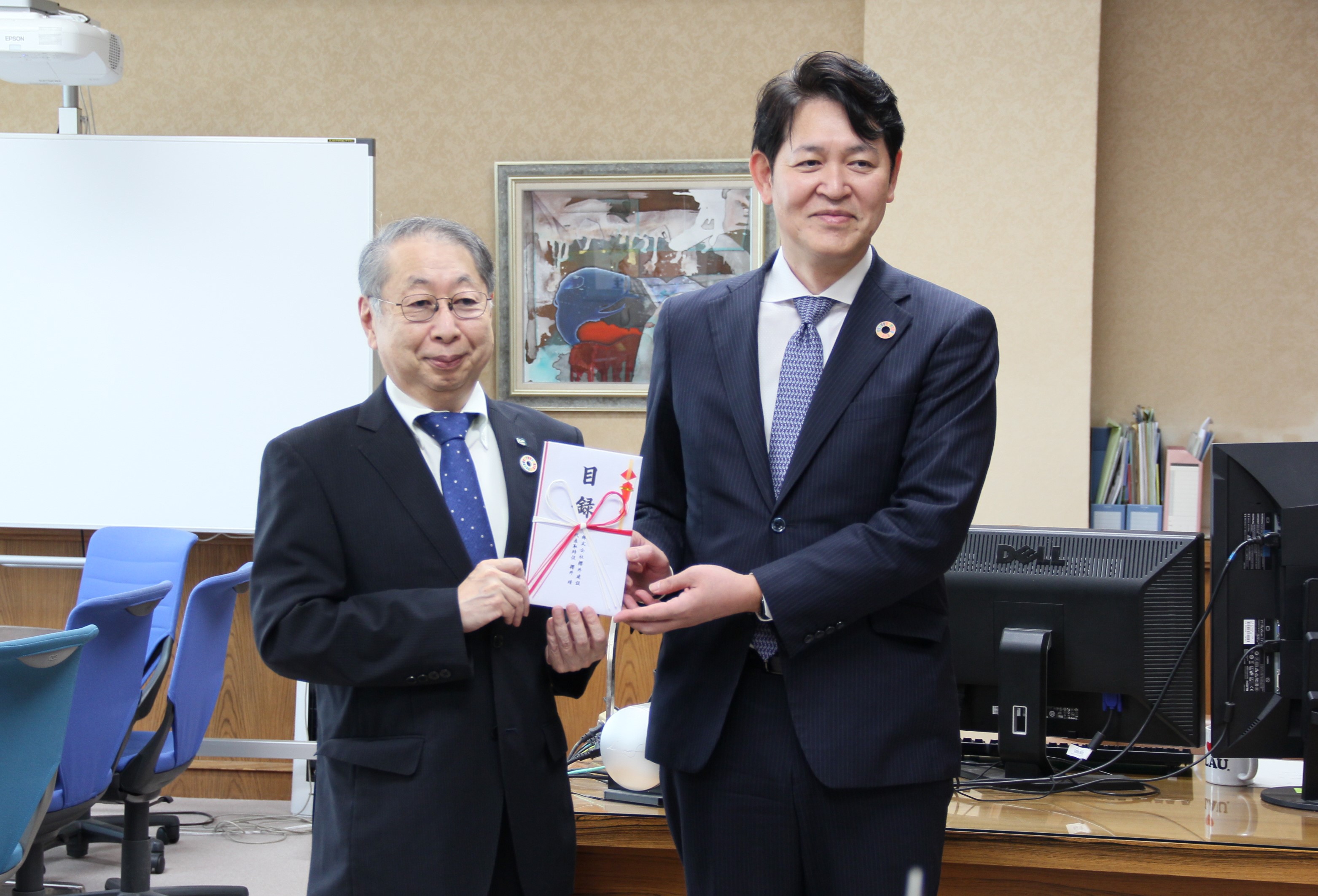 櫻井社長（右）から目録を贈呈される玉手学長の画像